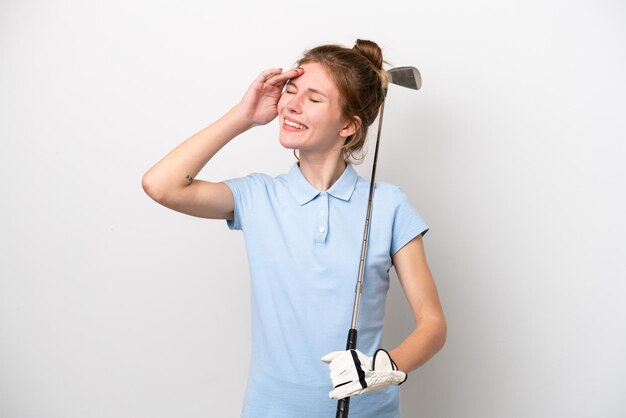 Junge englische Frau, die Golf lokalisiert auf weißem Hintergrund spielt, lächelt viel