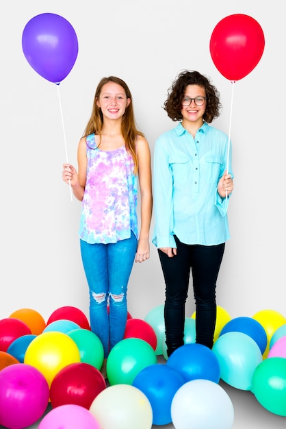 Junge erwachsene Frauen, die zusammen Ballon-Studio-Porträt halten