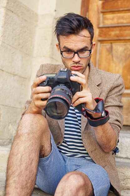 Junge Fotografen, die Fotos auf der Kamera betrachten