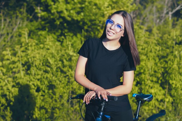 Junge Frau auf einem Fahrrad, das in der Natur reitet