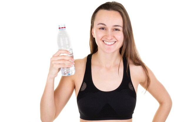 Junge Frau des schönen Eignungsathleten, die Trinkwasser nach Sportgymnastik stillsteht