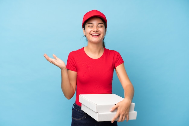 Junge Frau, die ein Pizzawandlachen hält