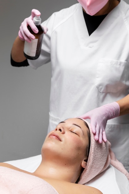 Foto junge frau, die eine gesichtsbehandlung am schönheitssalon hat