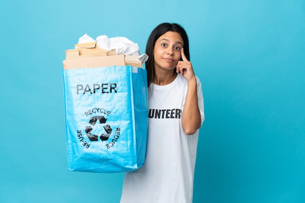 Junge Frau, die einen Recyclingbeutel voll Papier hält, der eine Idee denkt
