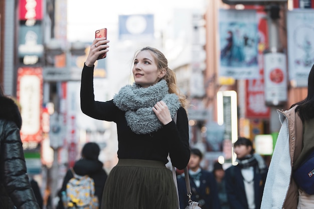 Junge Frau, die Fotos von der Stadt Tokio macht