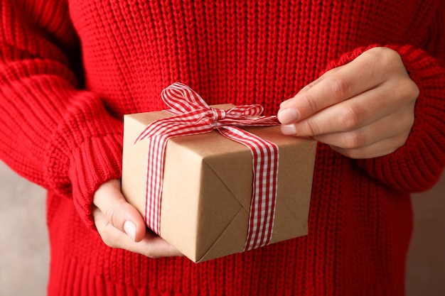 Junge Frau, die Geschenkbox mit Bogen, Nahaufnahme hält