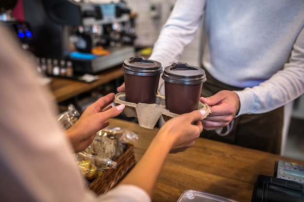 Junge Frau, die in einem Café zahlt