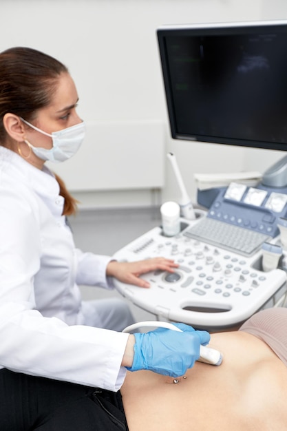 Junge Frau, die sich einer Ultraschalluntersuchung in einer modernen Klinik unterzieht