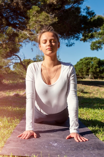 Junge Frau, die sich im Wald ausdehnt