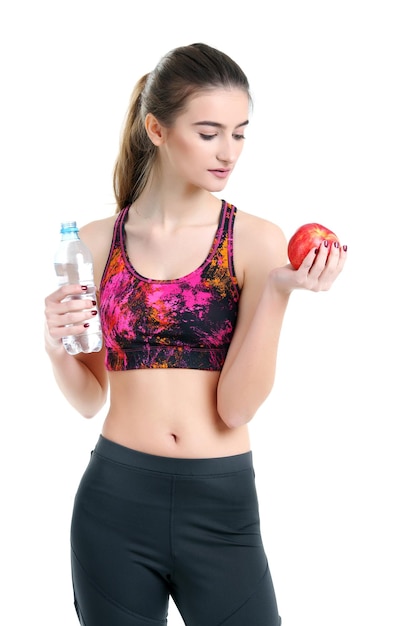 Junge Frau, die Sportkleidung trägt, trinkt Wasser