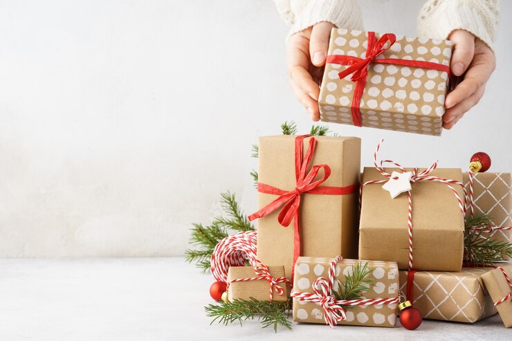 Junge Frau Hände, die eine Geschenkbox von einem großen Stapel von Geschenken nehmen