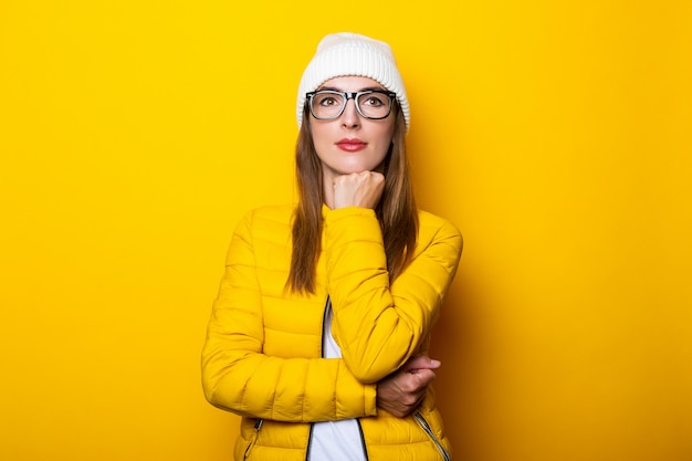 Junge Frau in Brille und gelber Jacke