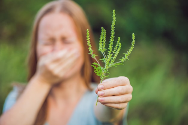 Foto junge frau niest wegen einer allergie gegen ambrosia