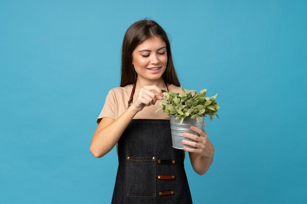 Junge Frau vorbei lokalisiert, einen Blumentopf nehmend