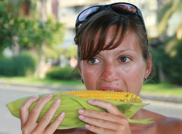 Foto junge frauen essen unordentliche maiskolben