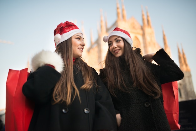 Junge Freundinnen, die zusammen vor Weihnachten kaufen