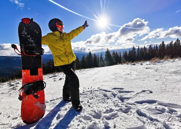 Junge glückliche Frau in den schneebedeckten Bergen. Wintersporturlaub.