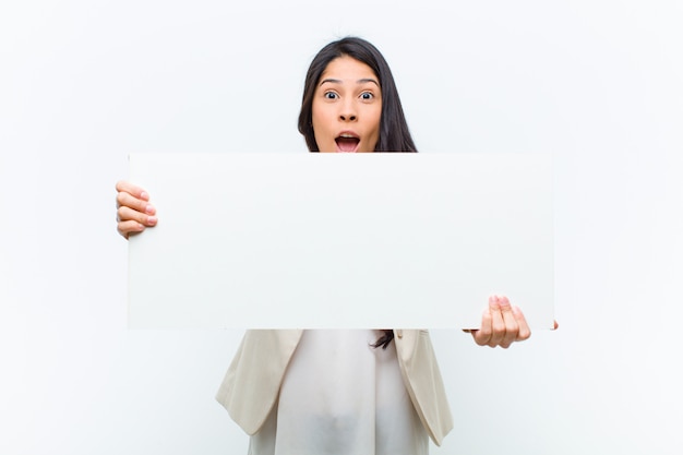 Junge hispanische hübsche Frau mit einem Plakat