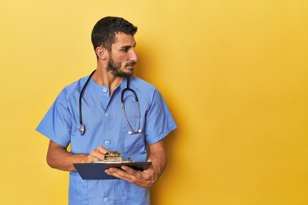 Foto junge hispanische krankenschwester hält einen medizinischen bericht in der hand