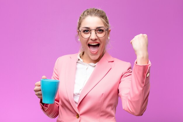 Junge hübsche blonde Frau mit einer Kaffeetasse