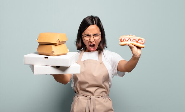 Junge hübsche Cheffrau. Fast-Food-Konzept