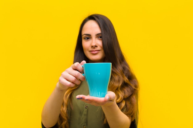 Junge hübsche Frau, die einen Kaffee trinkt