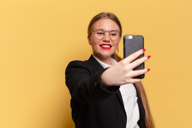 Junge hübsche Frau. glücklicher und überraschter Ausdruck. Smartphone-Konzept