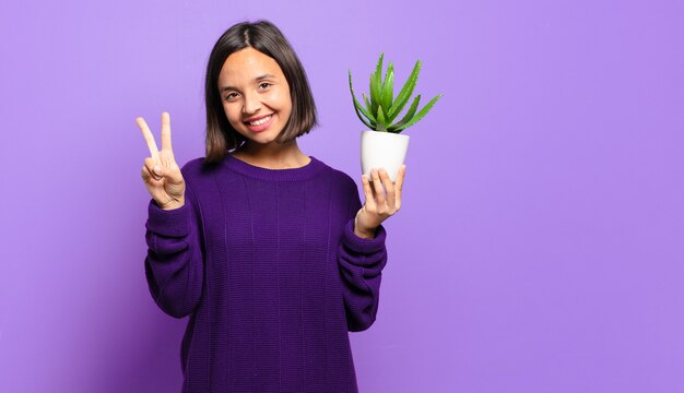 Junge hübsche Frau mit einem Kaktus