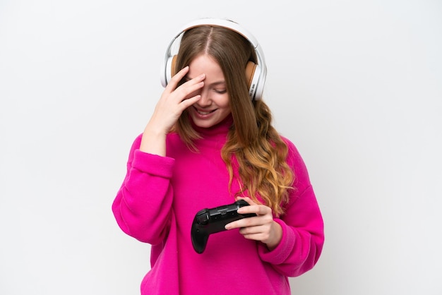 Junge hübsche Frau spielt mit einem Videospiel-Controller isoliert auf weißem Hintergrund lachend