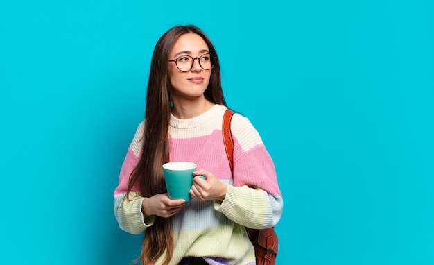 Junge hübsche Studentin Frau mit einer Kaffeetasse