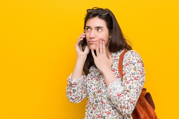 Junge kaukasische Frau, die ein Telefon anhält