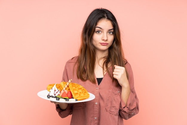 Junge kaukasische Frau, die Waffeln hält