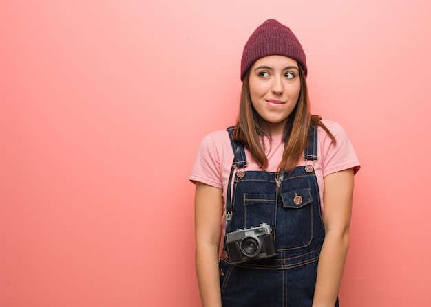 Junge nette Fotograffrau, die an eine Idee denkt