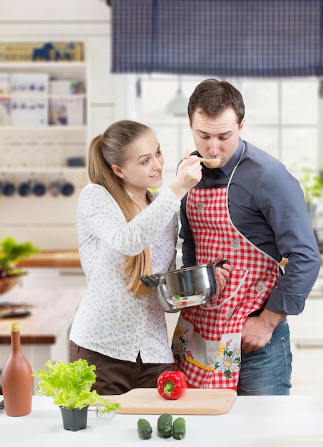 Junge Paare, die zusammen kochen