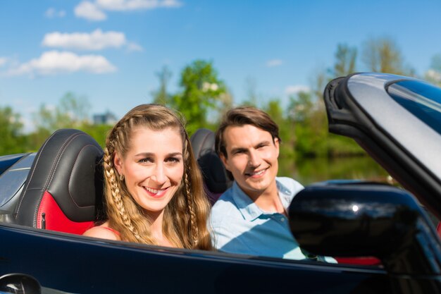 Junge Paare mit Cabriolet im Sommer auf Tagesreise