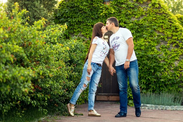 Junge romantische Paare haben Spaß miteinander im grünen Sommerpark.