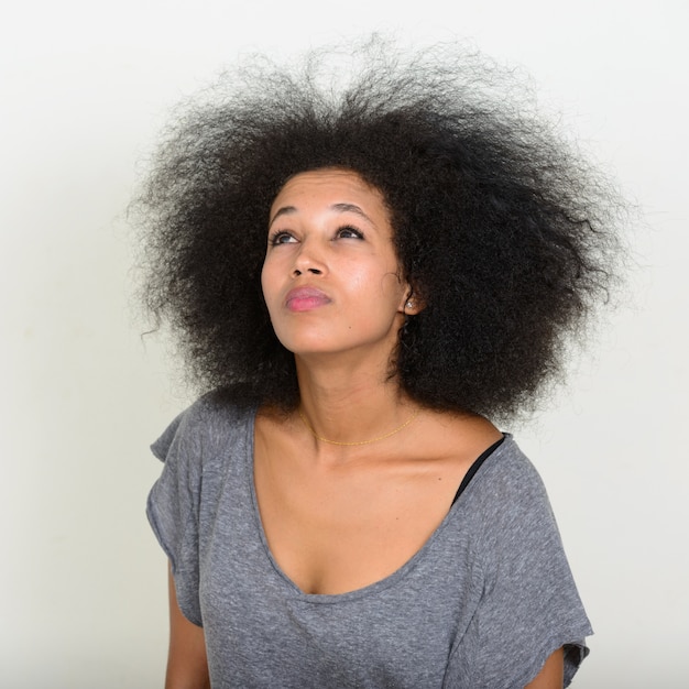 junge schöne afrikanische Frau mit Afro-Haaren auf Weiß