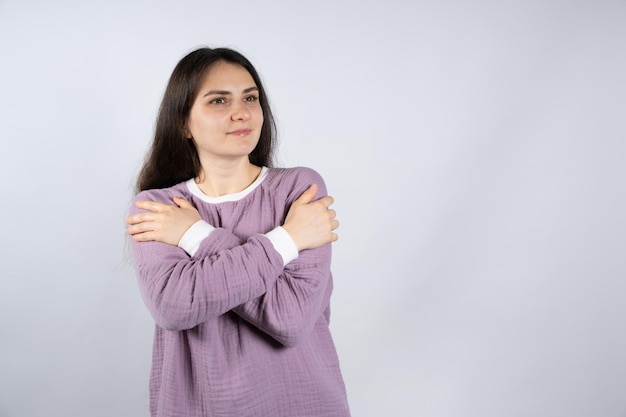 Junge schöne brünette Frau in lila bequemen Pyjamas