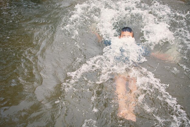 Foto junge schwimmt im see