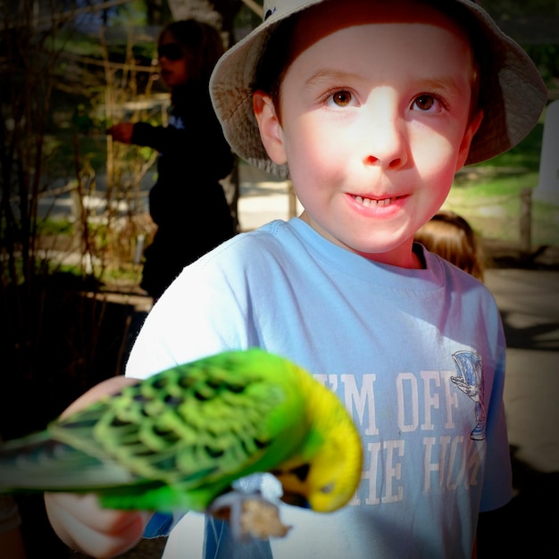Foto junge spielt mit einem papagei