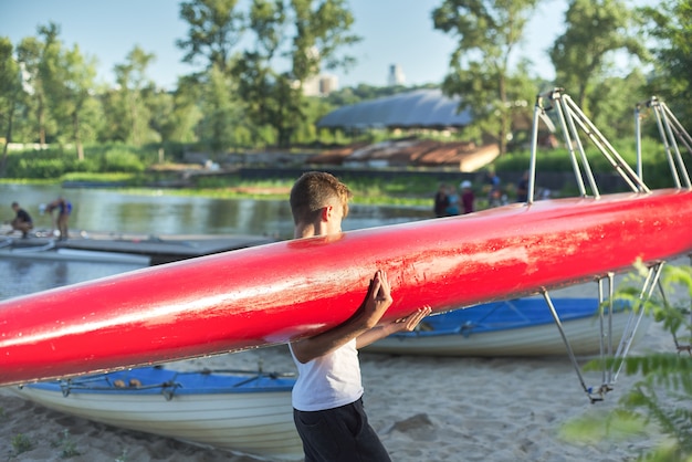 Junge Teenager mit Sportboot Kajak, Wassersport