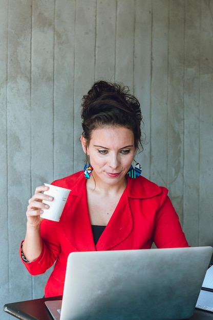 Junge Unternehmerfrau, die mit ihrem Laptop arbeitet