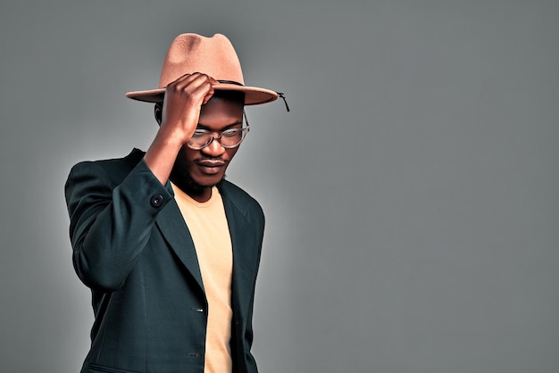 Junger afroamerikanischer Mann isoliert auf grauem Hintergrund mit Hut Kopierraum
