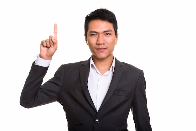 junger asiatischer Geschäftsmann, der Finger nach oben zeigt