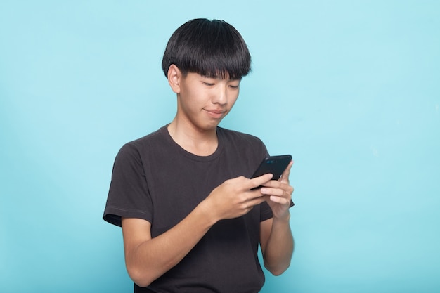 Junger asiatischer Mann mit Smartphone