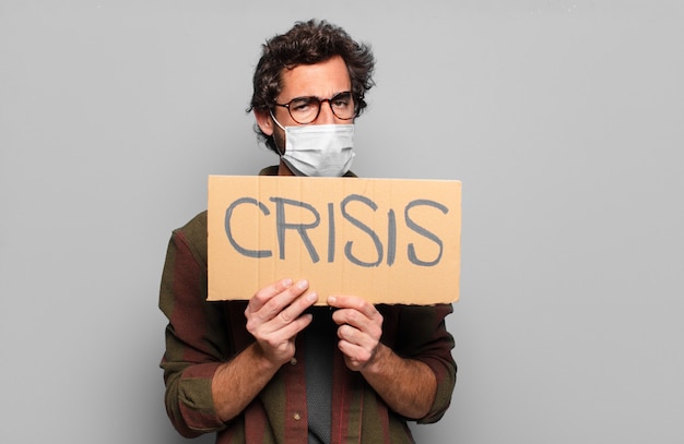 Foto junger bärtiger mann mit einer medizinischen maske. krisenkonzert