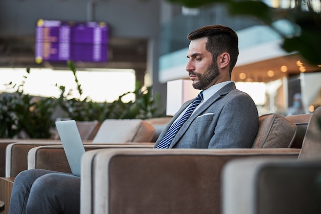 Junger Geschäftsmann konzentrierte sich auf seine Arbeit im Laptop