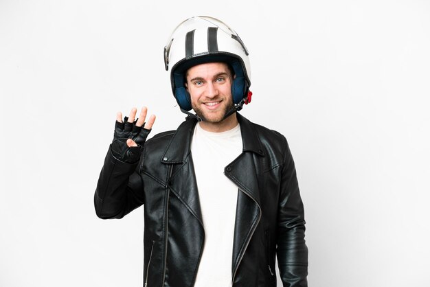 Junger gutaussehender blonder Mann mit Motorradhelm vor isoliertem weißem Hintergrund glücklich und vier mit den Fingern zählend