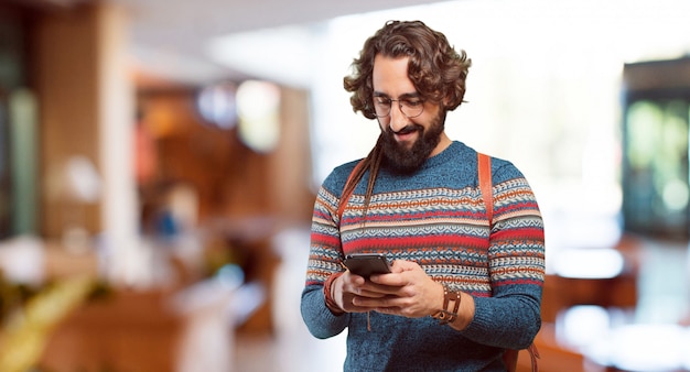 Junger Hippiemann mit einem intelligenten Telefon