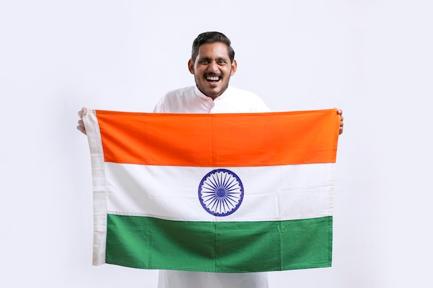 Foto junger indischer mann mit indischer nationalflagge in der hand auf weißem hintergrund holding